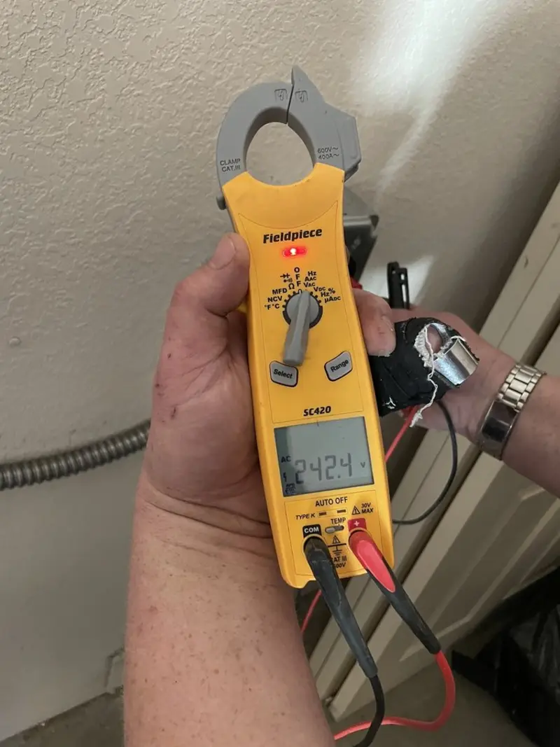 Voltage testing with clamp meter during Whole House Surge Protector in West Ocean City